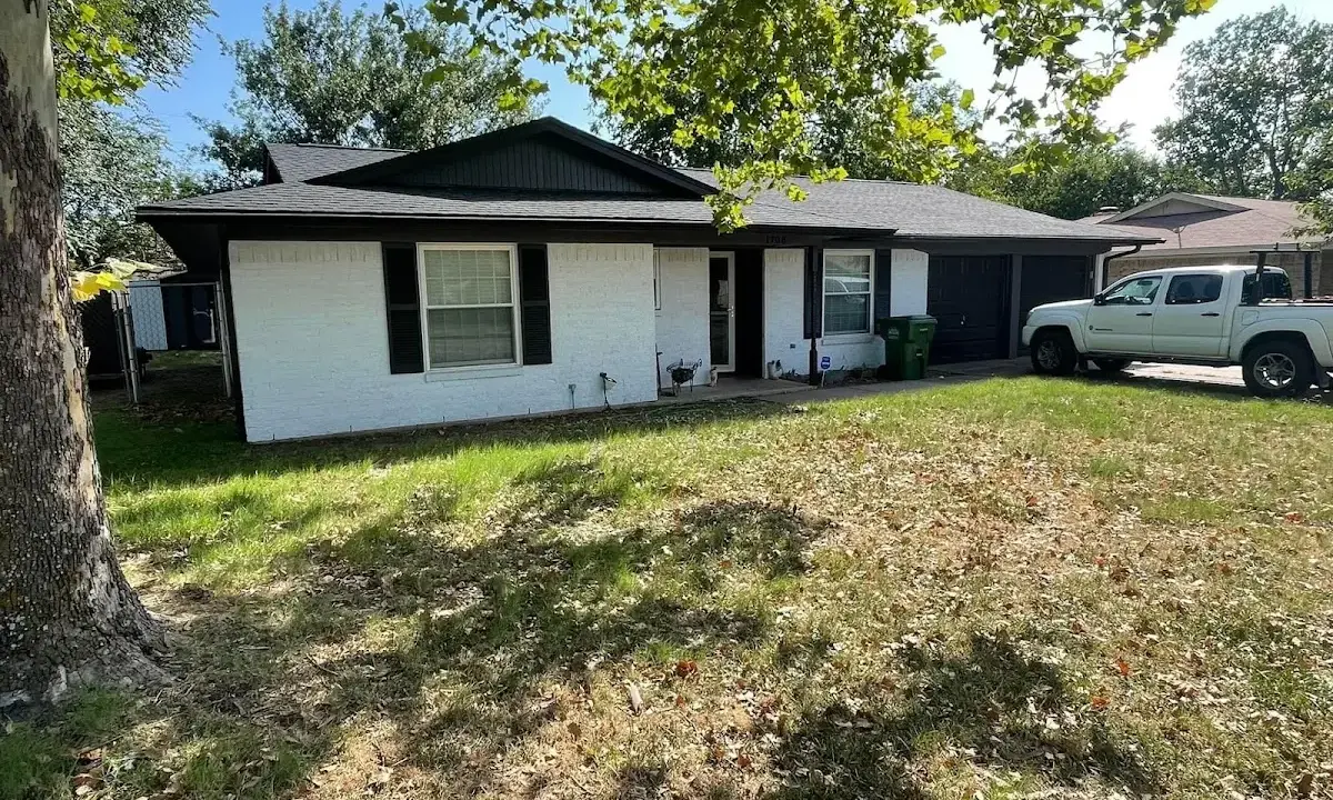 Professional roofing crew working on a residential roof in Davenport